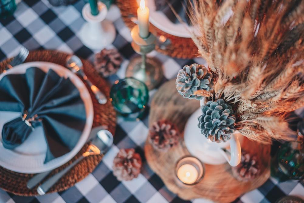 A beautifully set table with fall-themed decor in an upscale restaurant